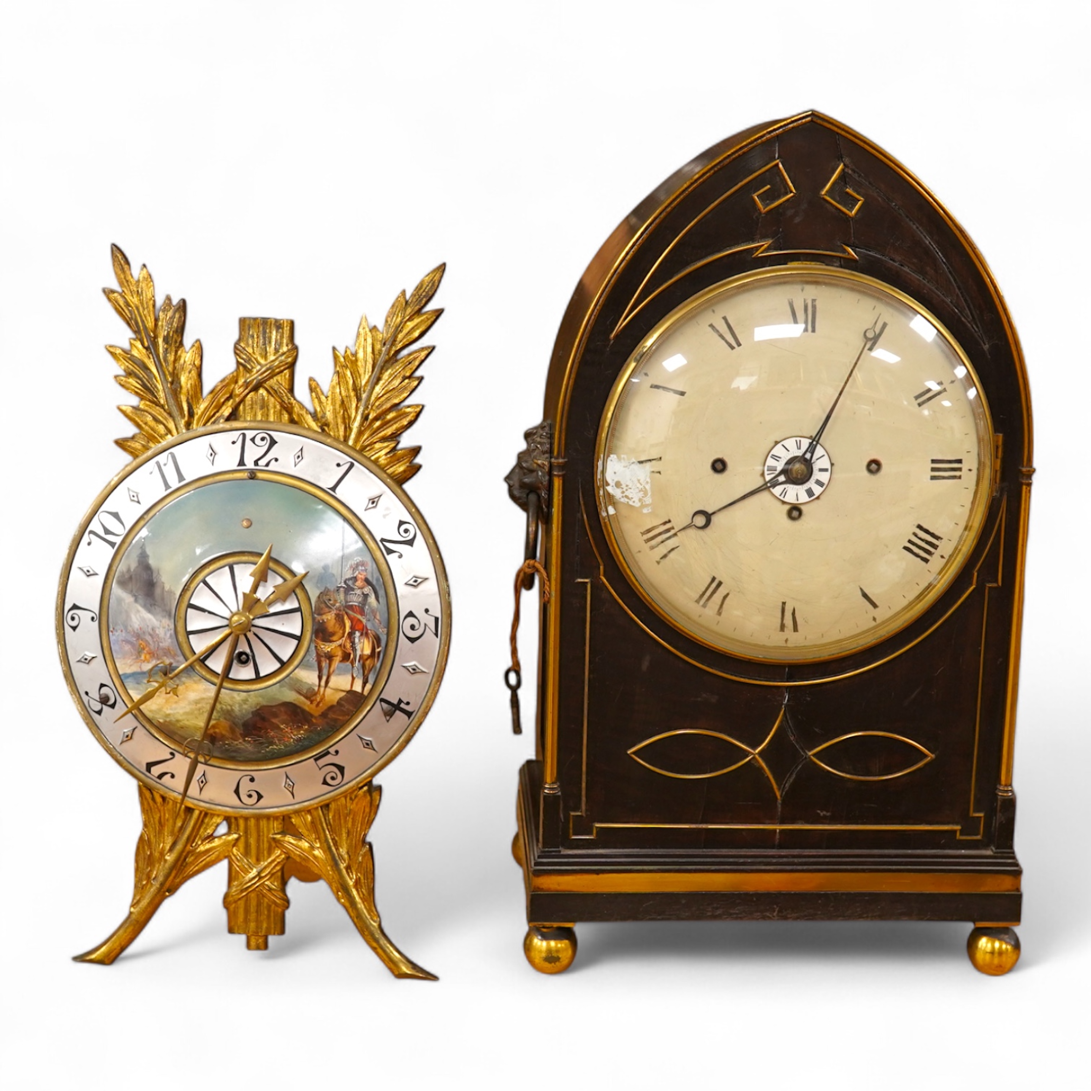 A Regency ebonised and brass inlaid lancet-shape bracket clock, with key and a painted pottery strut timepiece, largest 55cm high (2)